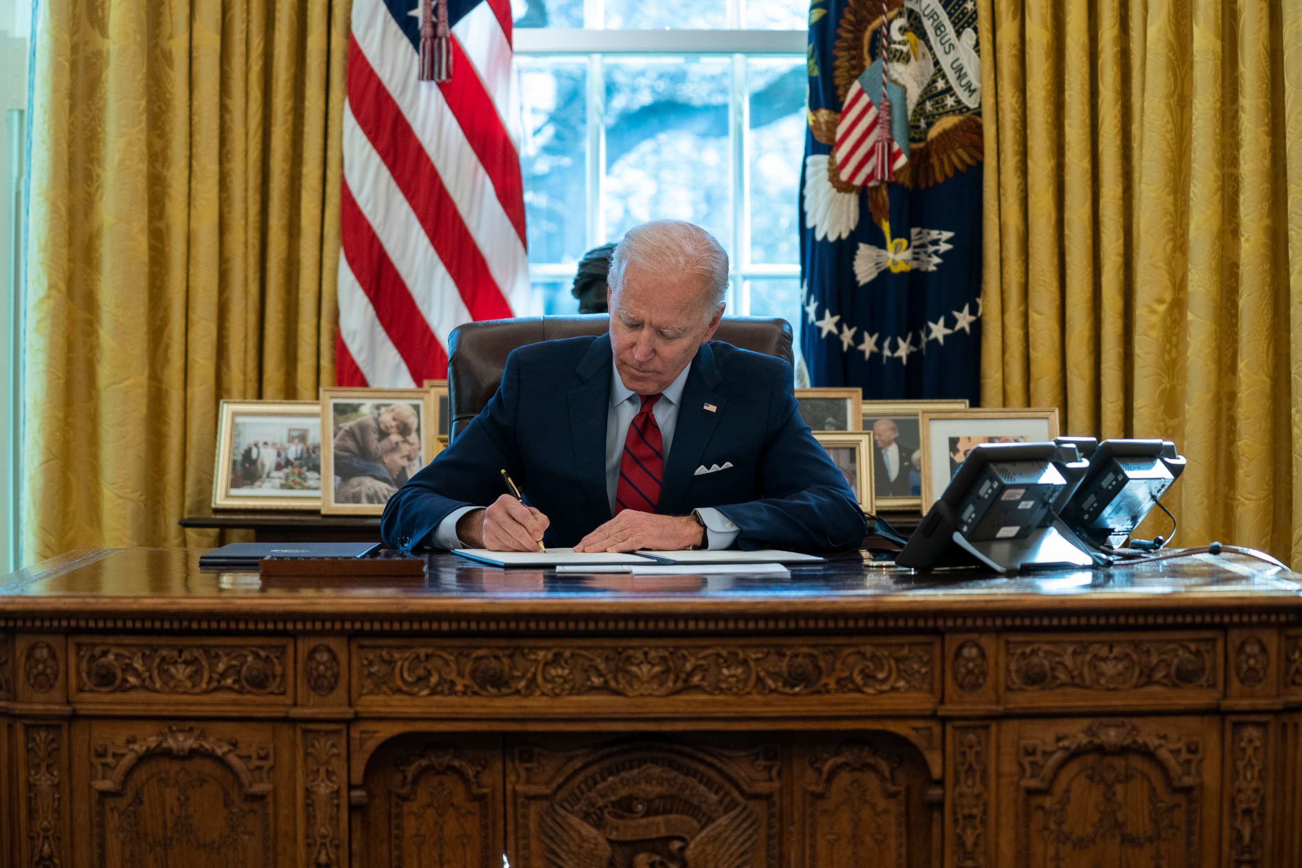 PHOTO: President Joe Biden signs a series of executive orders on health care, in the Oval Office of the White House in Washington, Jan. 28, 2021.