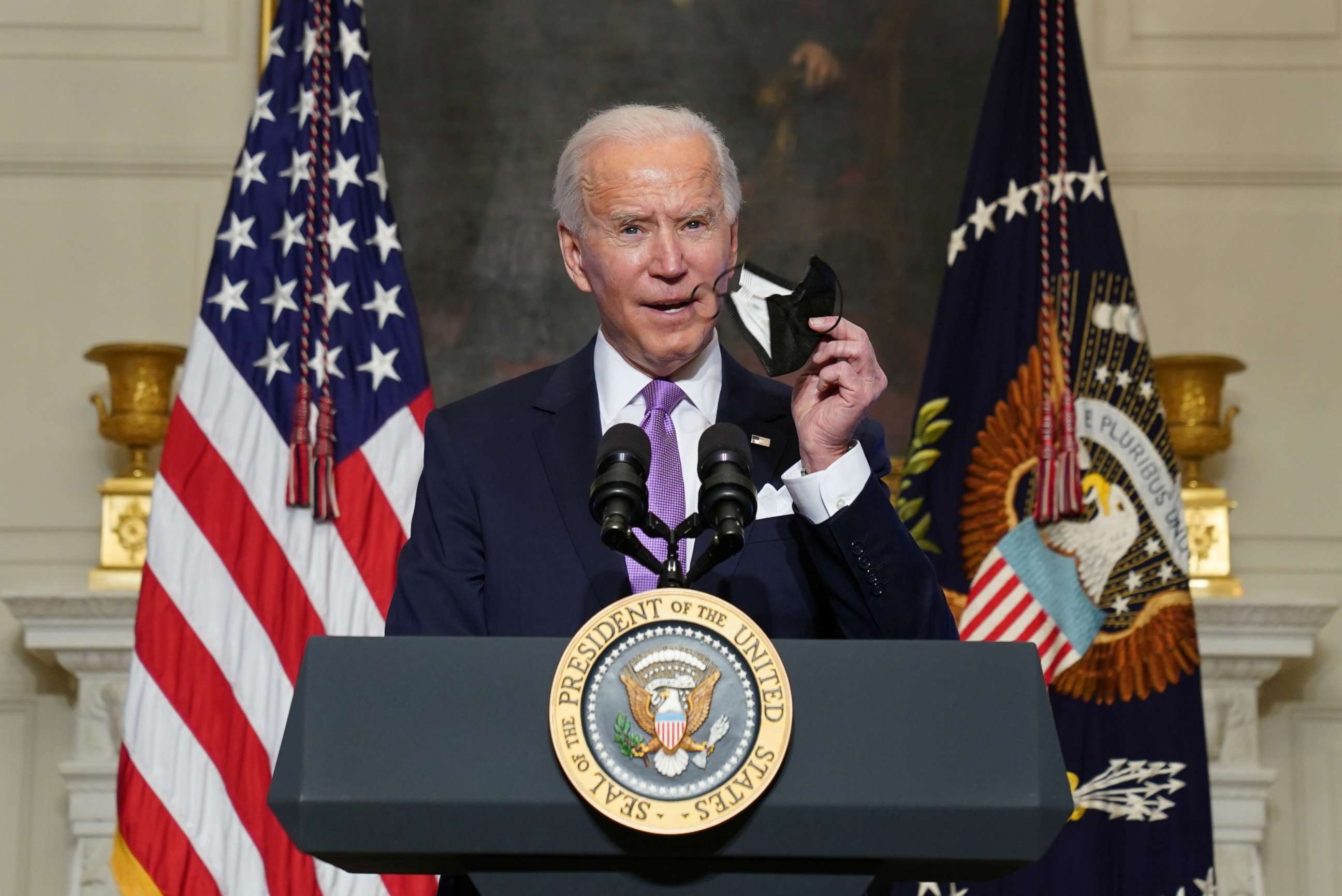 PHOTO: President Joe Biden holds up a face mask as he speaks about the fight to contain the coronavirus disease (COVID-19) pandemic, at the White House in Washington, Jan. 26, 2021.