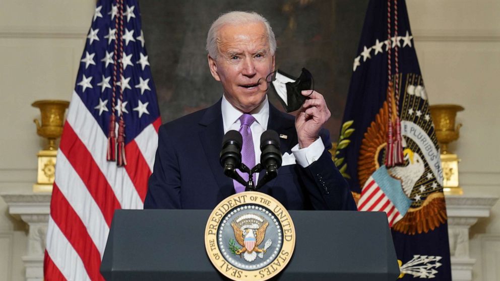 PHOTO: President Joe Biden holds up a face mask as he speaks about the fight to contain the coronavirus disease (COVID-19) pandemic, at the White House in Washington, Jan. 26, 2021.