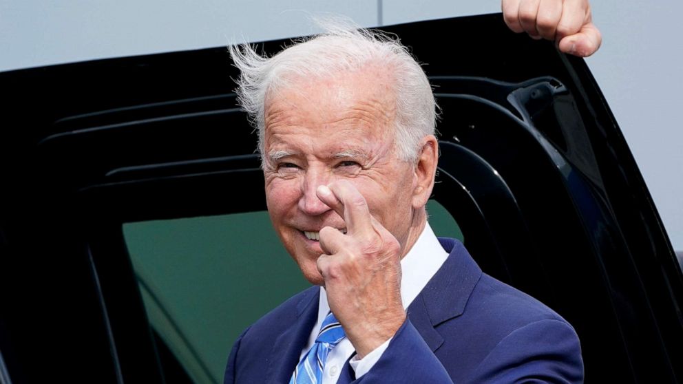 PHOTO: President Joe Biden crosses his fingers as he responds to a question about the short term debt deal, as he arrives at O'Hare International Airport in Chicago, Oct. 7, 2021. 