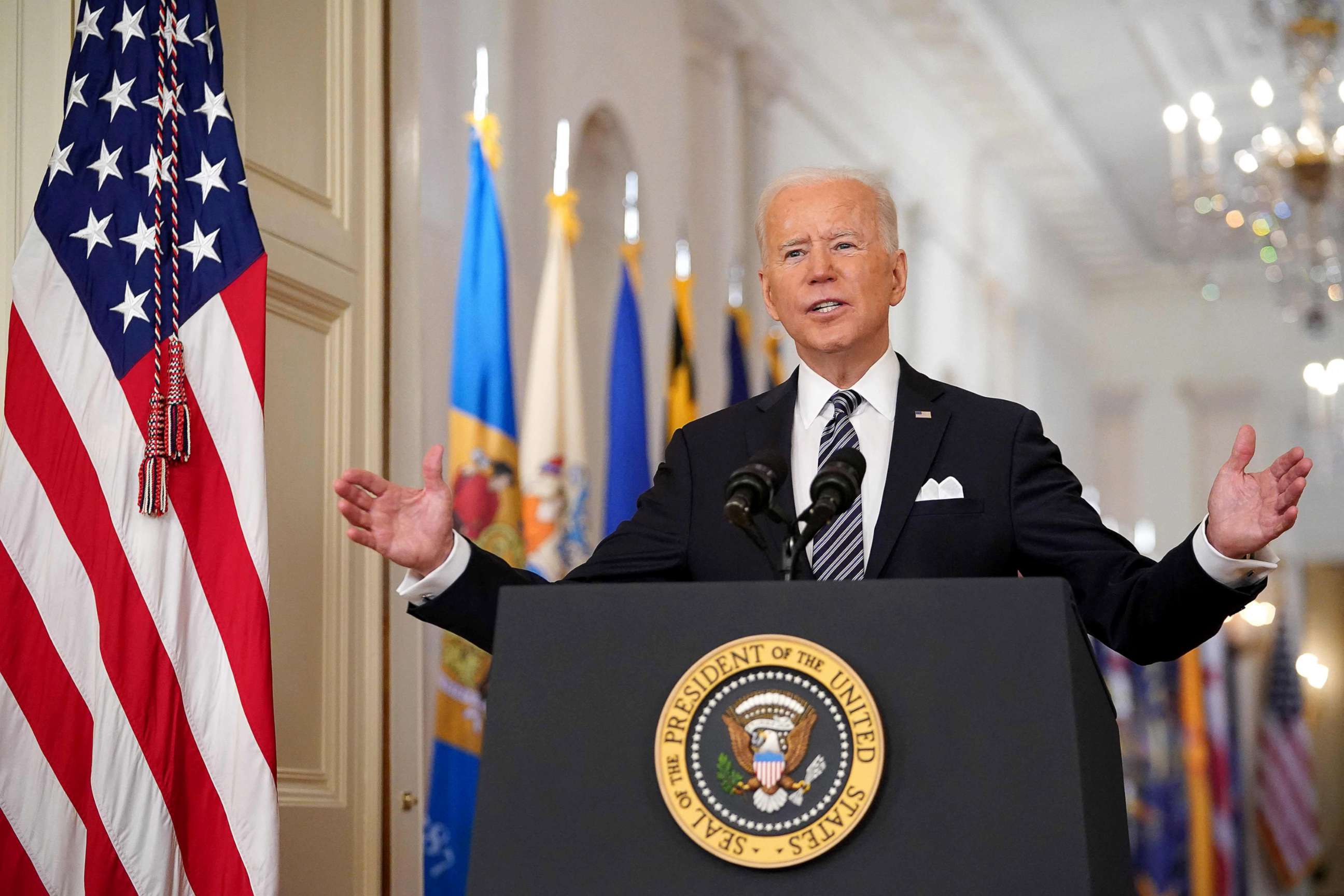 PHOTO:President Joe Biden gestures as he speaks on the anniversary of the start of the Covid-19 pandemic, in the East Room of the White House in Washington, DC on March 11, 2021. 