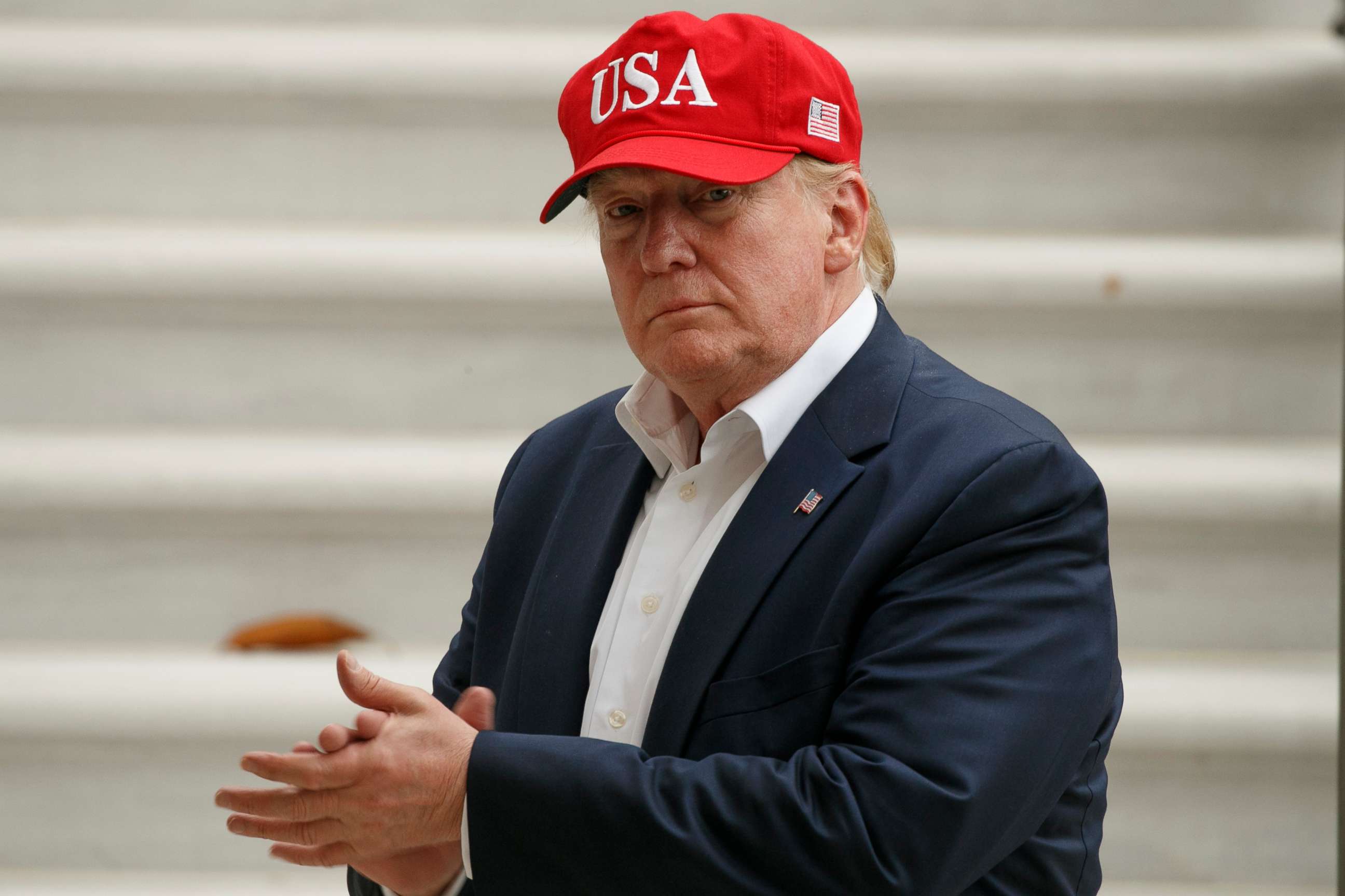 PHOTO: President Donald Trump claps after greeting supporters waiting at the White House with first lady Melania Trump as they returned to the White House, June 7, 2019, in Washington.