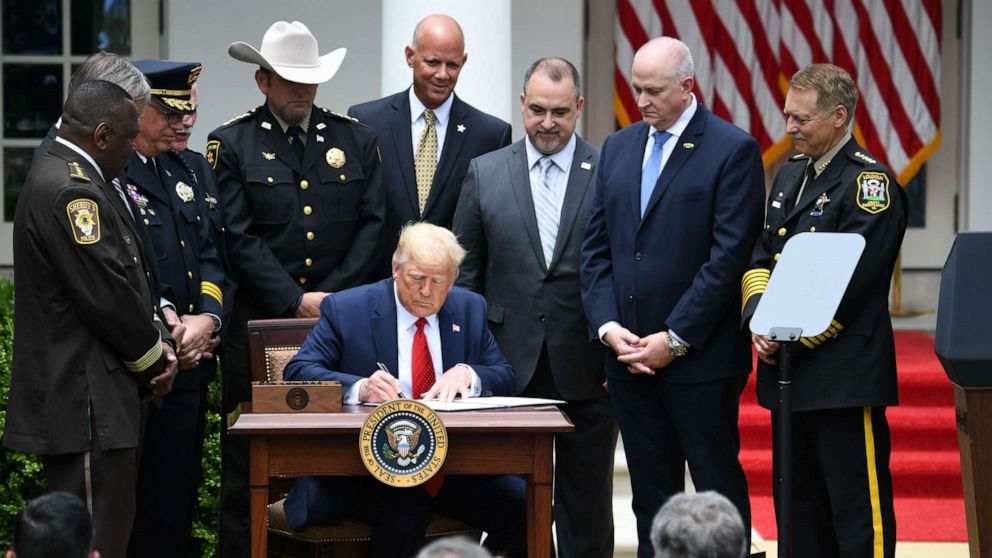 PHOTO: President Donald Trump signs an Executive Order on Safe Policing for Safe Communities, in the Rose Garden of the White House in Washington, June 16, 2020.