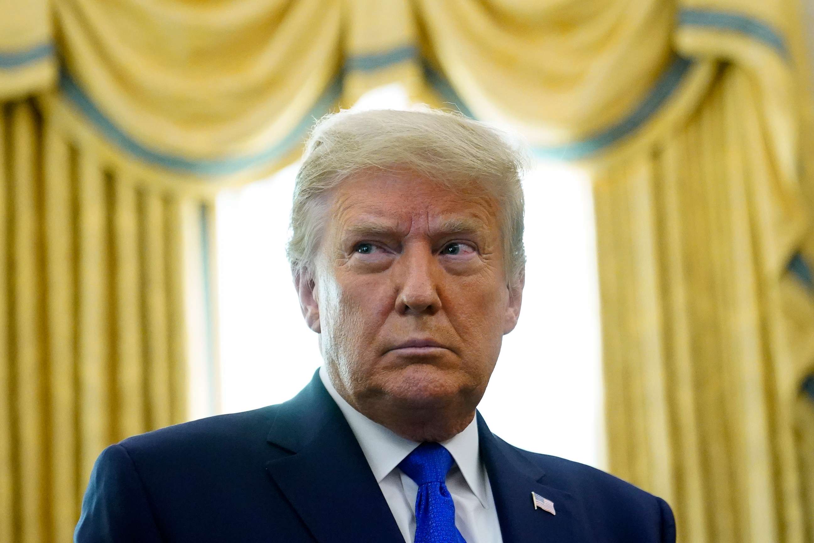 PHOTO: President Donald Trump stands in the Oval Office of the White House, Dec. 7, 2020.