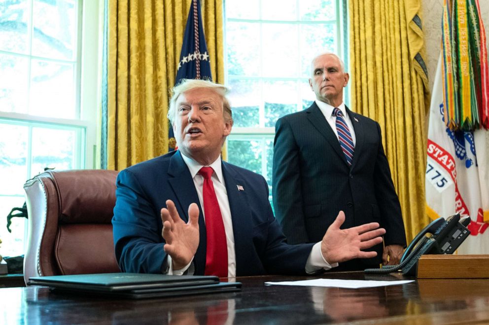 PHOTO: Vice President Mike Pence watches President Donald Trump speak after he signed an executive order for additional sanctions against Iran and its leadership, in the Oval Office at the White House in Washington, June 24, 2019.