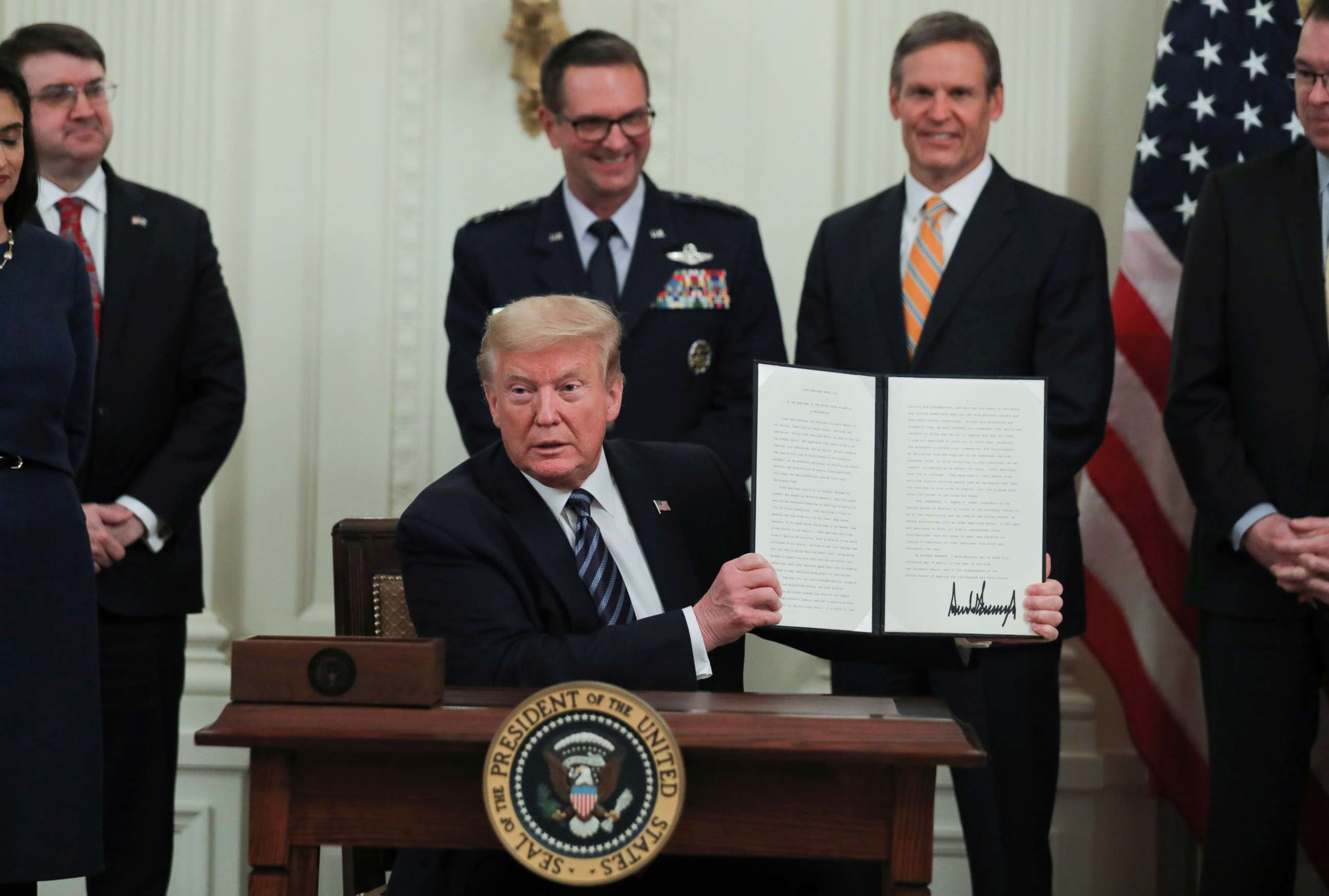 PHOTO: President Donald Trump holds up a presidential proclamation declaring an "Older Americans Month 2020" during an event about senior citizens and the coronavirus disease (COVID-19) pandemic in Washington, April 30, 2020. 