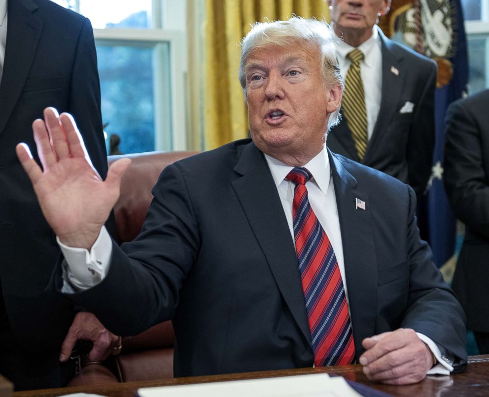 PHOTO: President Donald Trump speaks to the press pool after signing S.3021, America's Water Infrastructure Act of 2018, in the Oval Office of the White House, Oct. 23, 2018.