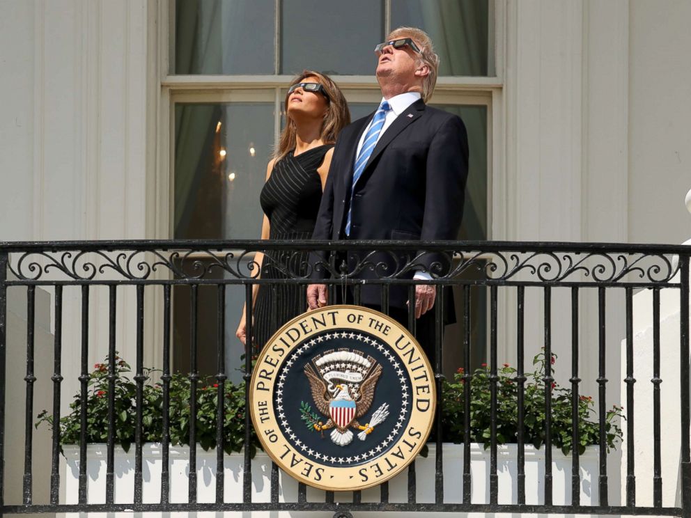 PHOTO: President Donald Trump and first lady Melania Trump wear protective glasses as they view the solar eclipse, Aug. 21, 2017, at the White House.