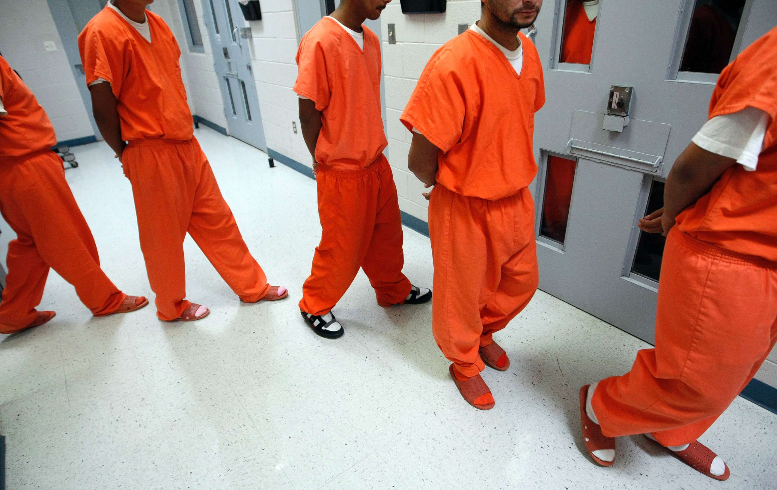 PHOTO: New federal inmates prepare to undergo health screenings while being processed at the Val Verde Correctional Facility in Del Rio, Texas.