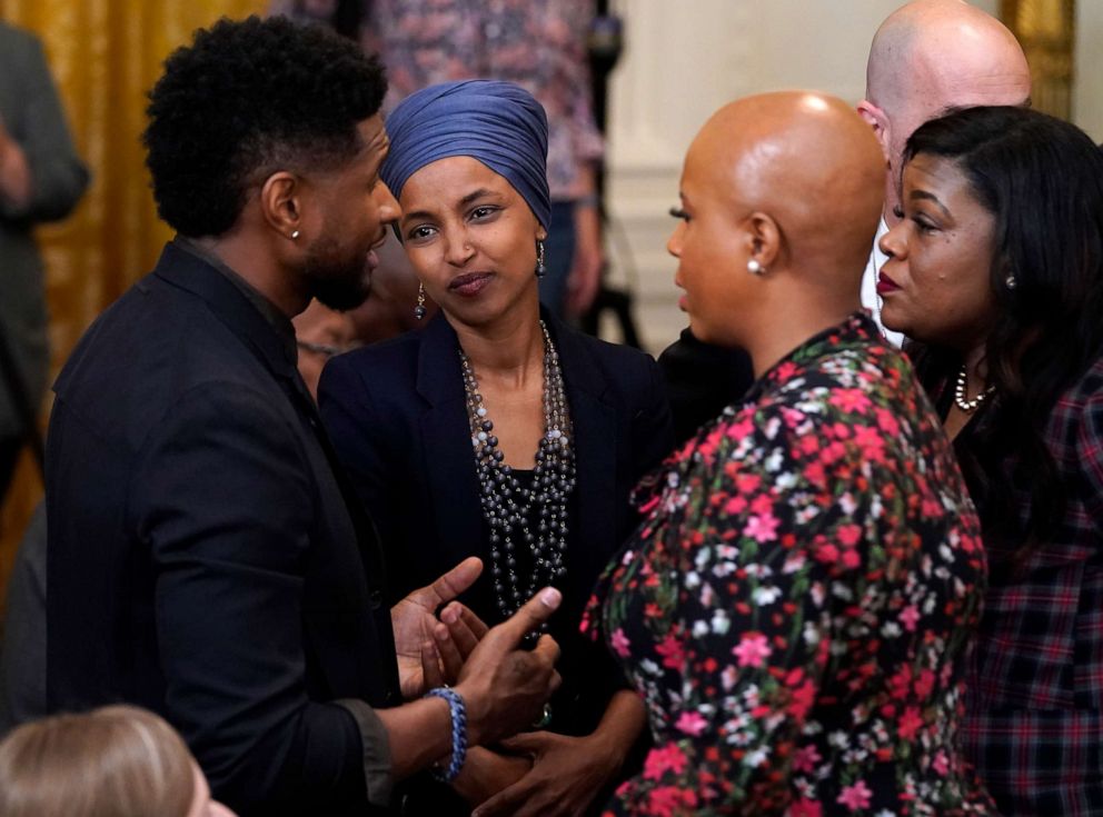 PHOTO: Usher speaks with Rep. Ilhan Omar, D-Minn., second from left, and Rep. Ayanna Pressley, D-Mass., second from right, as they arrive for an event to mark the passage of the Juneteenth National Independence Day Act, June 17, 2021, in Washington.
