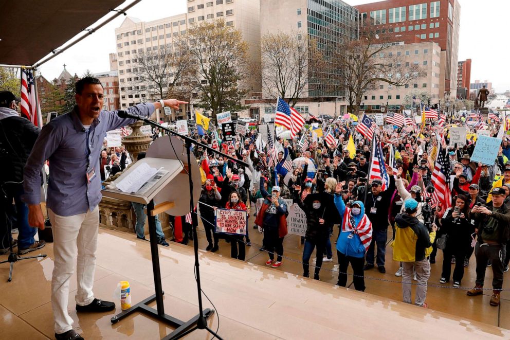 PHOTO: Ryan Kelley, a protest organizer, for the American Patriot Rally organized by the Michigan United for Liberty for the reopening of businesses stands on the steps of the Michigan State Capitol in Lansing, Michigan on April 30, 2020.