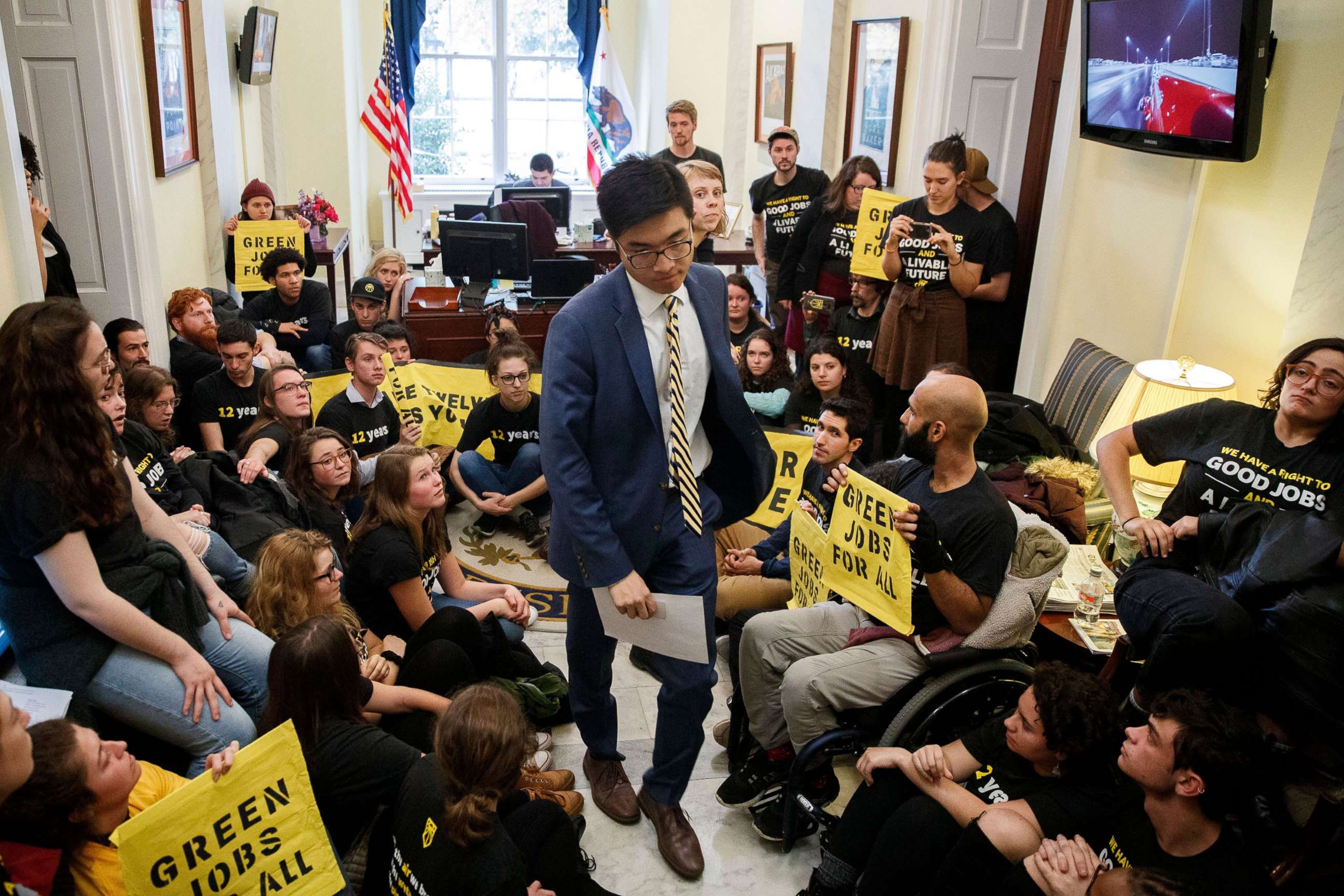 PHOTO: Activists from Sunrise Movement and Justice Democrats sit outside House Minority Leader Nancy Pelosi's office on Capitol Hill in Washington, Nov. 13, 2018.