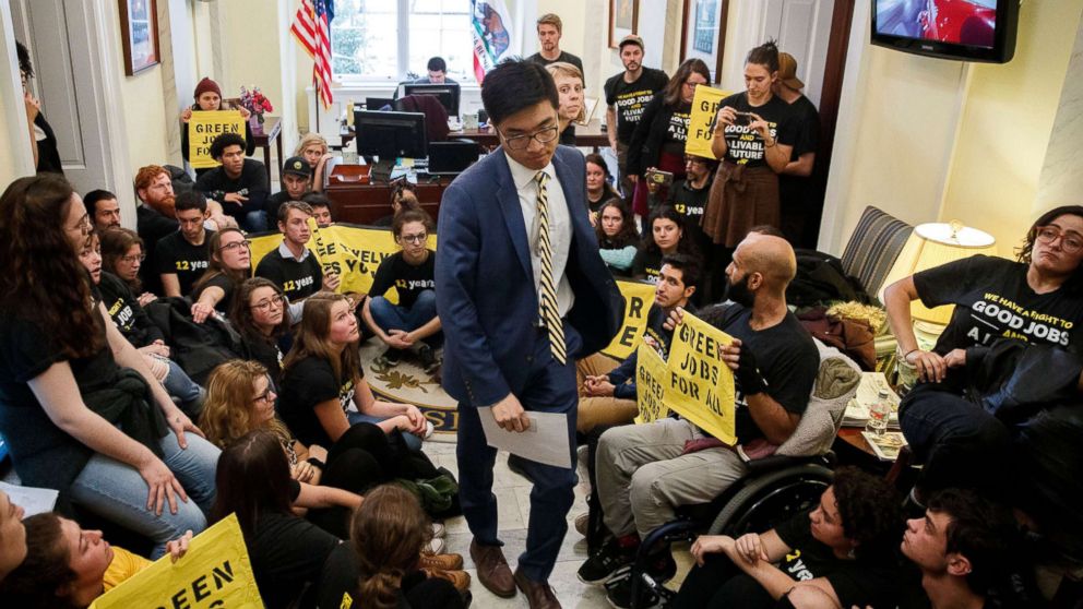 PHOTO: Activists from Sunrise Movement and Justice Democrats sit outside House Minority Leader Nancy Pelosi's office on Capitol Hill in Washington, Nov. 13, 2018.