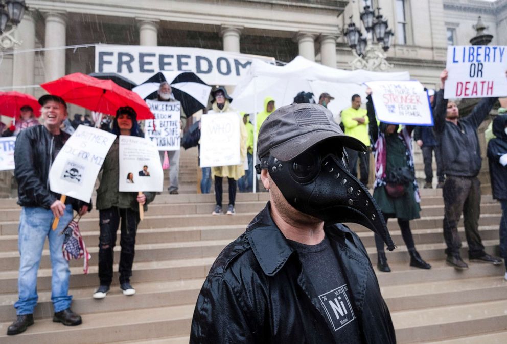 PHOTO: A protester wears a Plague mask during a protest against Governor Gretchen Whitmer's extended stay-at-home orders intended to slow the spread of the coronavirus disease (COVID-19) at the Capitol building in Lansing, Mich., May 14, 2020. 