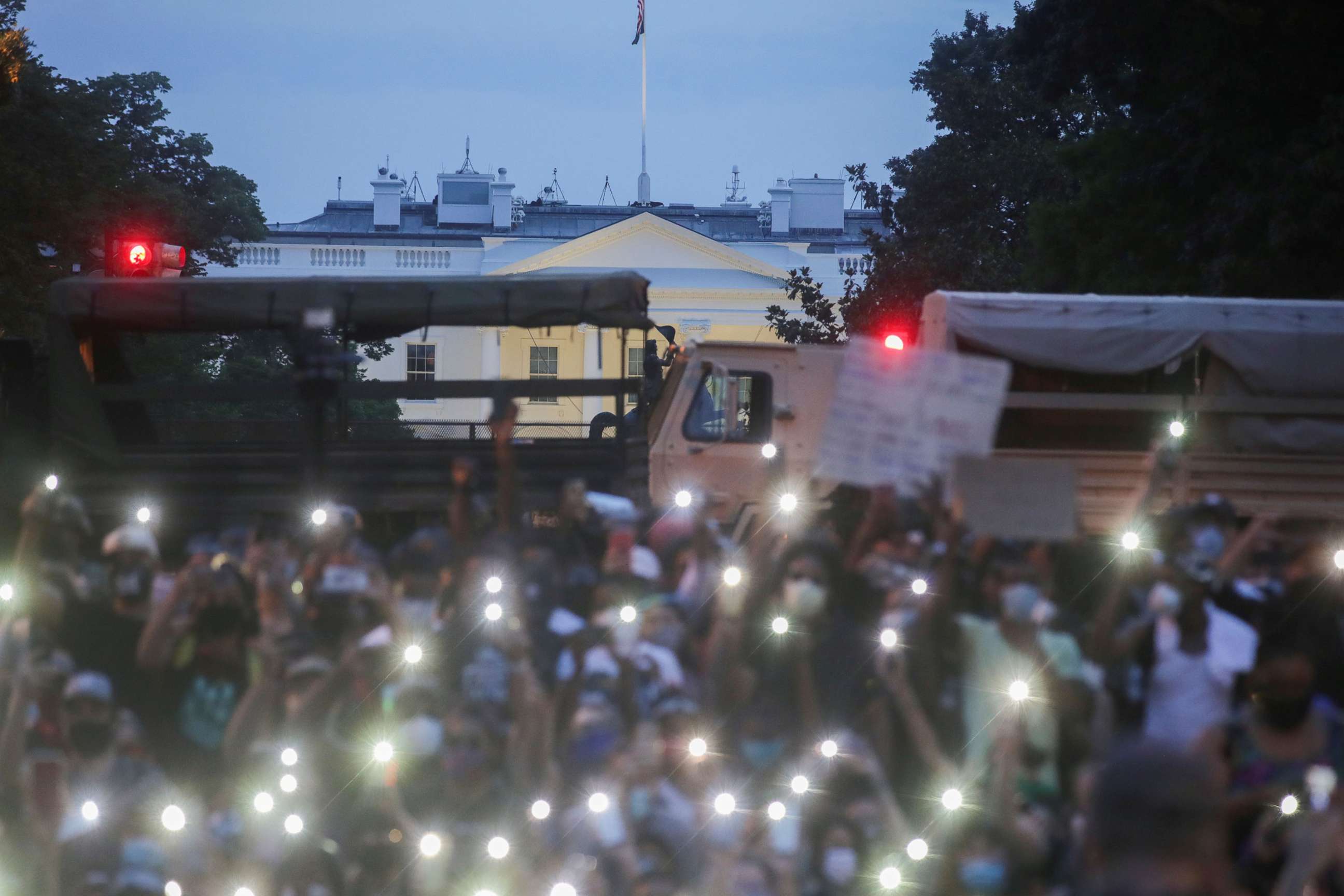 PHOTO: Demonstrators use the light of their cellphones as they gather during a protest against the death in Minneapolis police custody of George Floyd, near the White House in Washington, June 3, 2020.