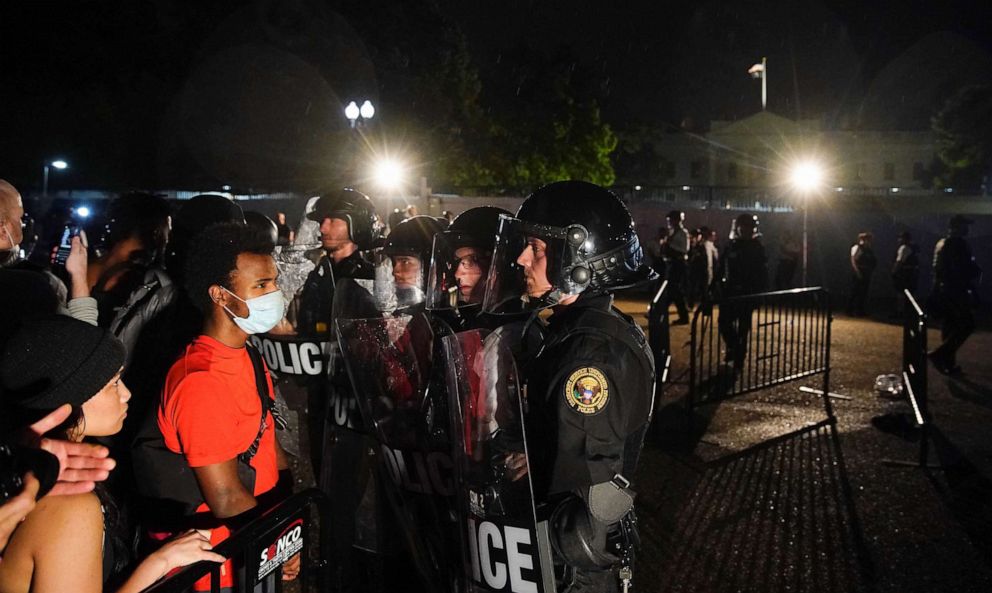 PHOTO: In this May 29, 2020, photo, demonstrators face off with Secret Service uniformed division officers in riot gear holding them back from the White House as they protest against the death in Minneapolis police custody of George Floyd.