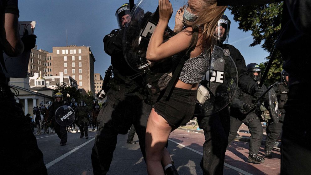 PHOTO: Riot police rush demonstrators as they clear Lafayette Park and the area around it across from the White House for President Donald Trump to be able to walk through for a photo opportunity, June 1, 2020.