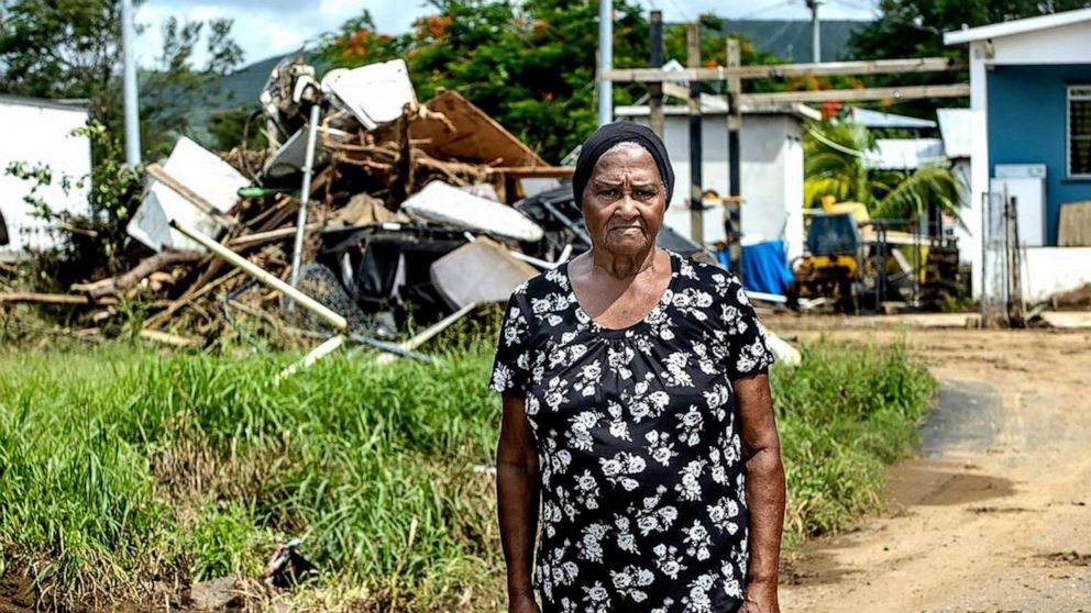 PHOTO: Brunilda Colaan, 79, an iconic figure in her neighborhood, stands amid hurricane damage near her house in Salinas, Puerto Rico, Sept. 23, 2022.