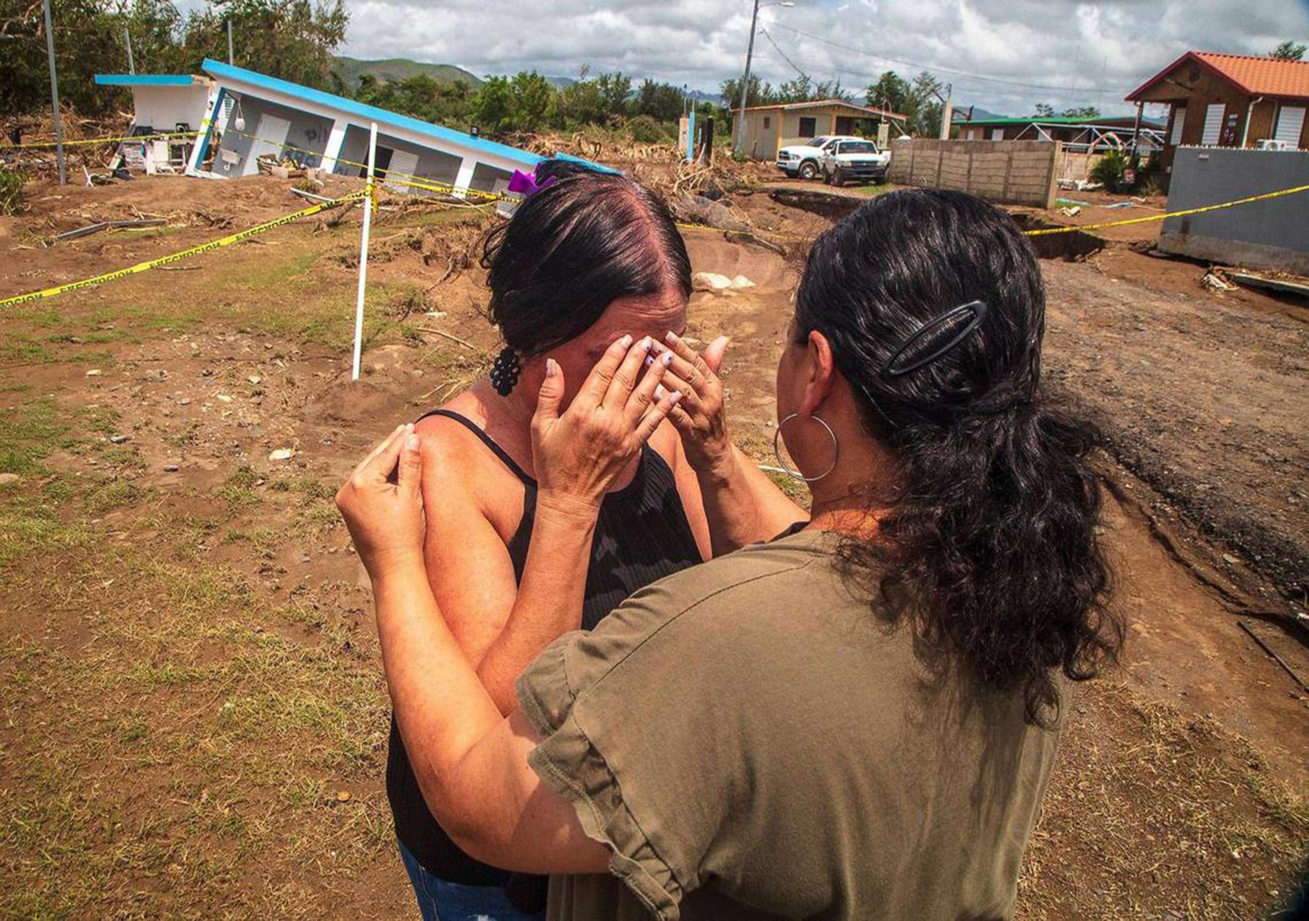 PHOTO: Doris Romero comforts her neighbor Leida Rodriguez, whose house collapsed into a sink hole after flooding from the Nigua River during Hurricane Fiona at Villa Esperanza in Salinas, Puerto Rico,Sept. 23, 2022.