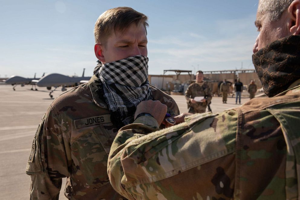 PHOTO: Spc. Robert Jones is presented the Purple Heart medal by 34th Expeditionary Combat Aviation Brigade Commander, Col. Greg Fix, on May 3, 2020, for his injuries sustained during the ballistic missile attacks at Al Asad Air Base, Iraq, on January 8.