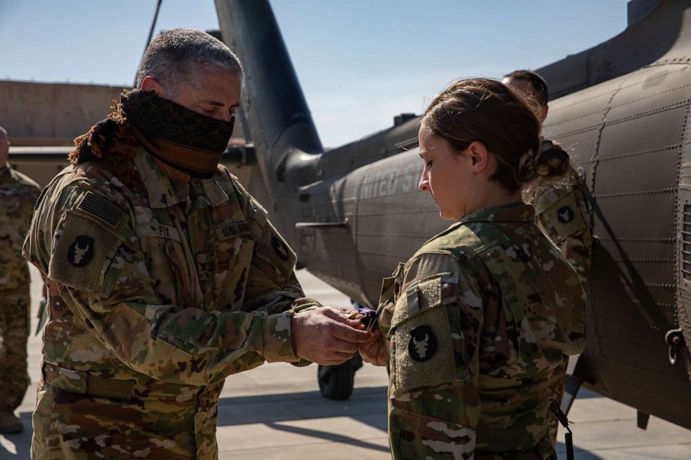 PHOTO: First Lt. Abigail Holstein is presented with the Purple Heart medal by Col. Greg Fix, on May 3, 2020, for her injuries sustained during the ballistic missile attacks at Al Asad Air Base, Iraq, on January 8.