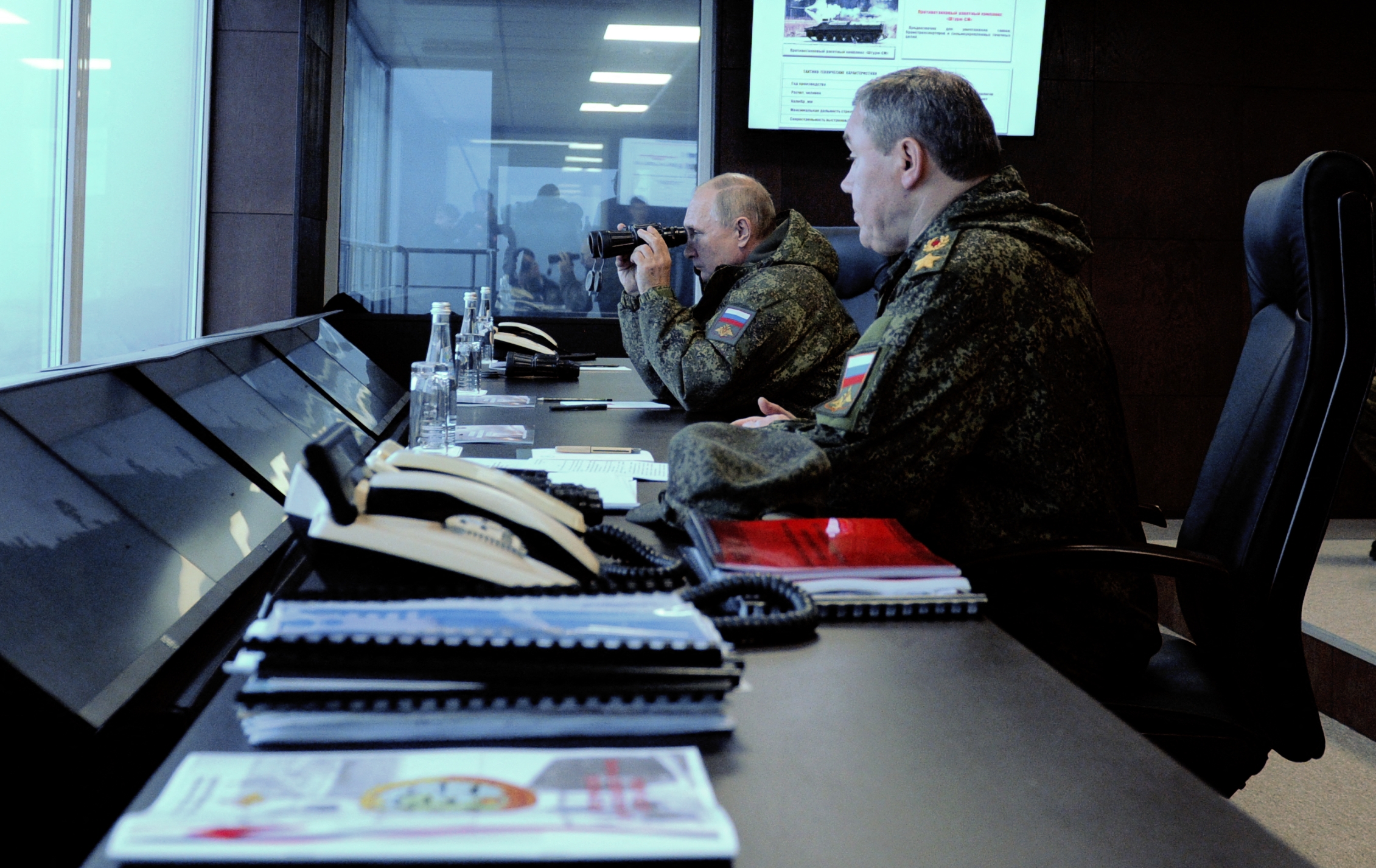 PHOTO: Russian President Vladimir Putin (L), accompanied by Valery Gerasimov, the chief of the Russian General Staff, oversees the 'Vostok-2022' military exercises at the Sergeevskyi training ground outside the city of Ussuriysk, Sept. 6, 2022. 