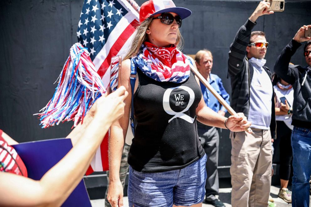 PHOTO: Conspiracy theorist QAnon demonstrators protest during a rally to re-open California and against Stay-At-Home directives on May 1, 2020 in San Diego, California.