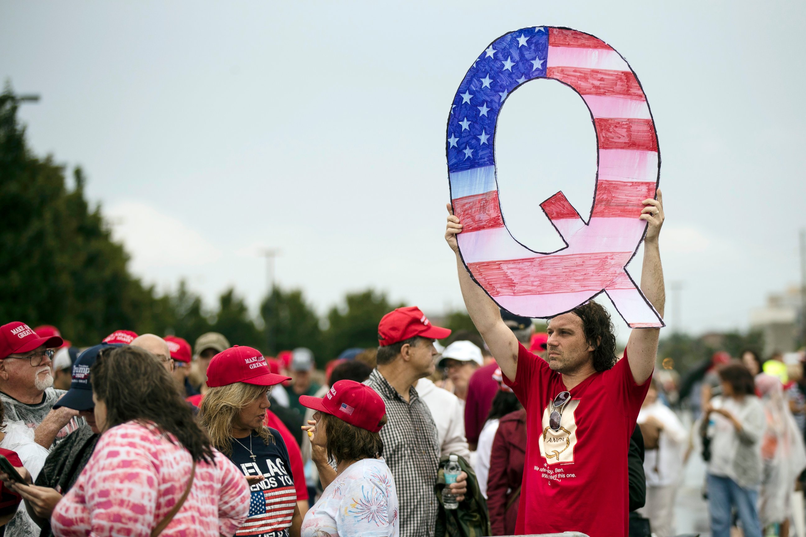 PHOTO: In this Aug. 2, 2018, file photo, a protesters holds a Q sign waits in line with others to enter a campaign rally with President Donald Trump in Wilkes-Barre, Pa.