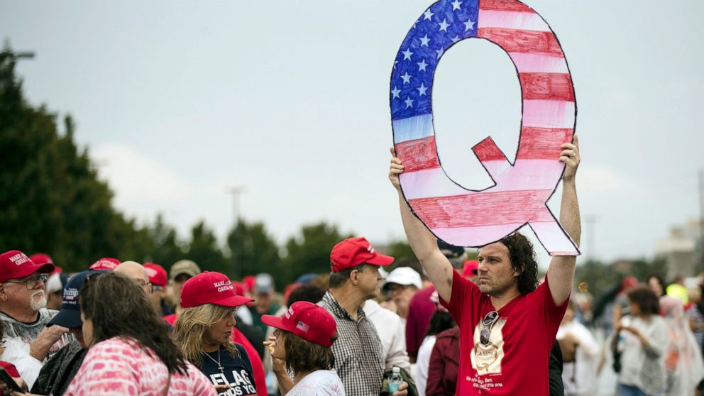 PHOTO: In this Aug. 2, 2018, file photo, a protesters holds a Q sign waits in line with others to enter a campaign rally with President Donald Trump in Wilkes-Barre, Pa.