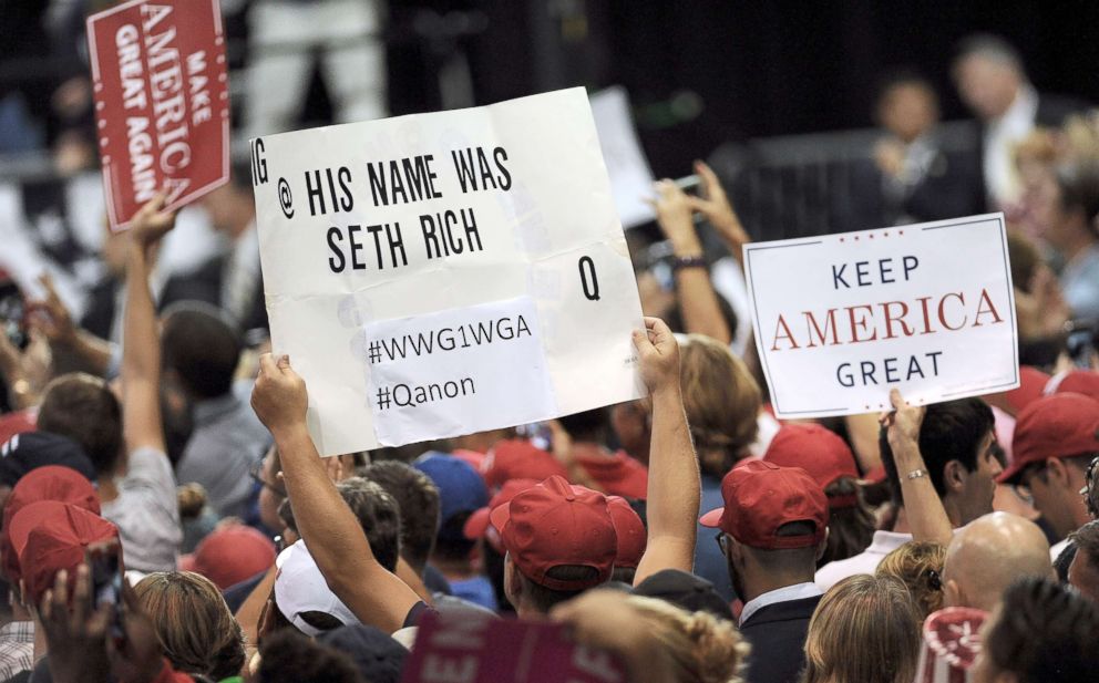 PHOTO: An attendee at President Donald Trump's Make America Great Again Rally holds a sign regarding the debunked Seth Rich murder conspiracy theory, July 31, 2018, at the Florida State Fairgrounds in Tampa, Fla.