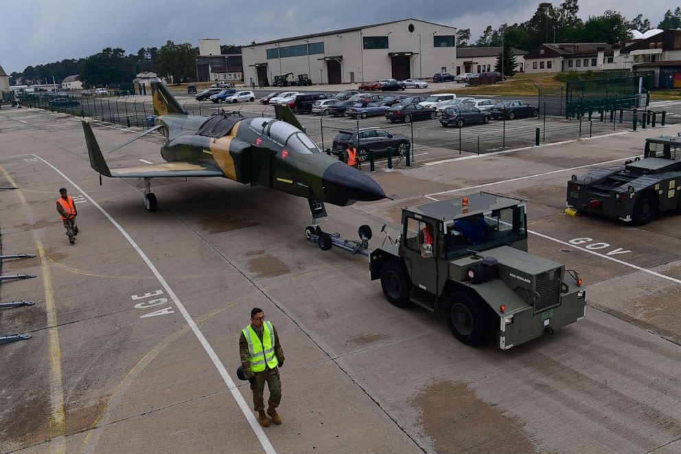 PHOTO: Airmen from the 86th Maintenance Squadron and local nationals from the 435th Construction and Training Squadron tow an RF-4C Phantom II aircraft to be put on static display at Ramstein Air Base, Germany, June 4, 2020.