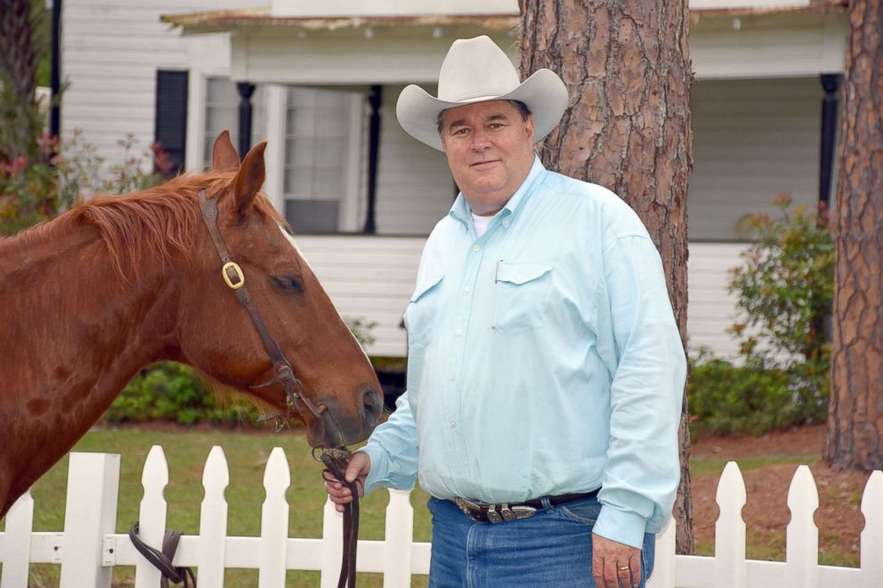 PHOTO: Marty Smith stands with his horse on his ranch in Wacahoota, Florida.