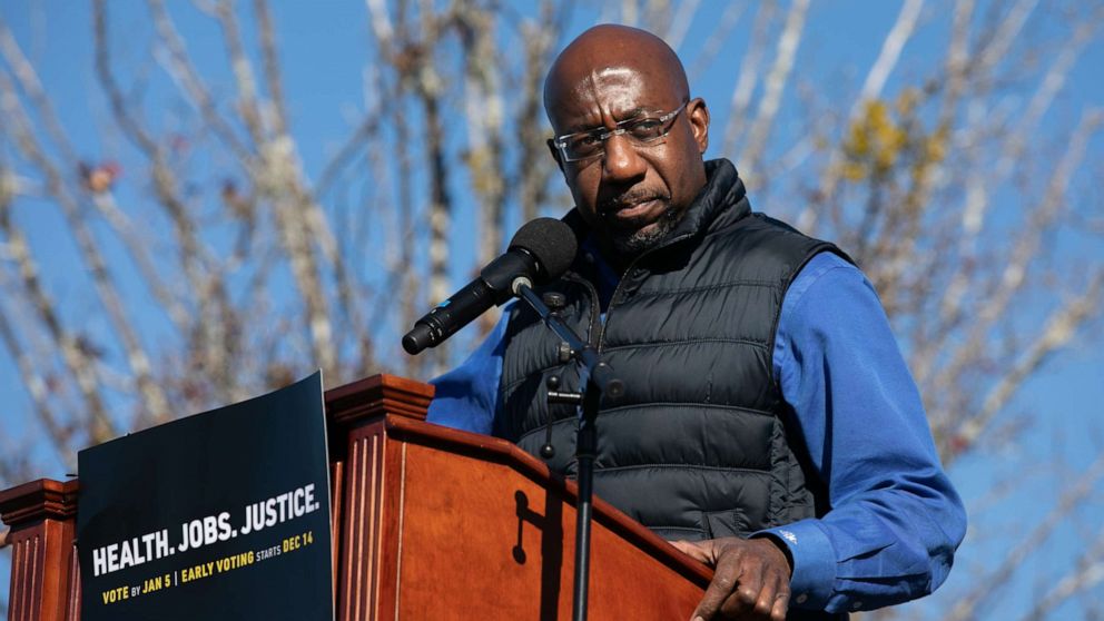 PHOTO: Democratic Senate candidate Raphael Warnock speaks to the crowd during an outdoor drive-in rally, Dec. 5, 2020, in Conyers, Georgia.