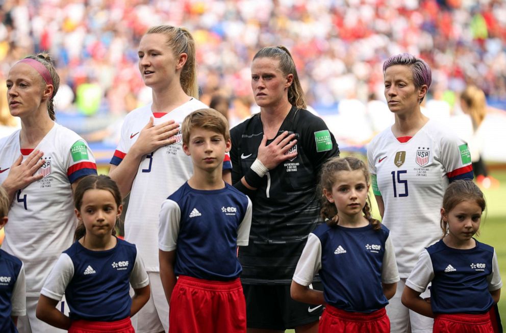 PHOTO: United States Megan Rapinoe, right, stands with her teammates during the national anthem before the Womens World Cup final soccer match between US and The Netherlands at the Stade de Lyon in Decines, outside Lyon, France, July 7, 2019.