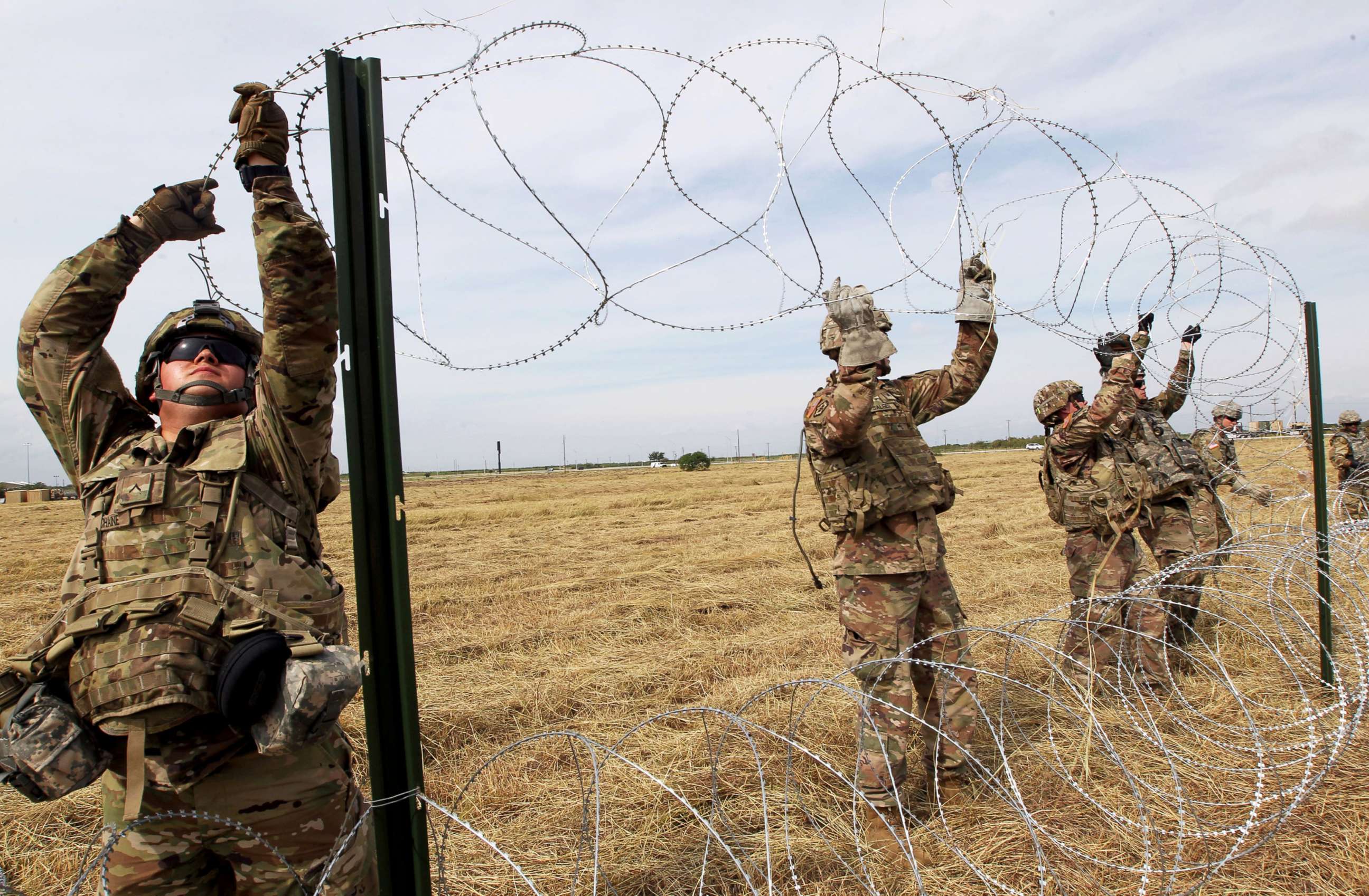 PHOTO: Army soldiers from Ft. Riley, Kansas, put up razor wire fence for an encampment to be used by the military near the U.S. Mexico border in Donna, Texas, Nov. 4, 2018.