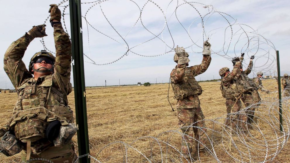 Army soldiers from Ft. Riley, Kansas, put up razor wire fence for an encampment to be used by the military near the U.S. Mexico border in Donna, Texas, Nov. 4, 2018.