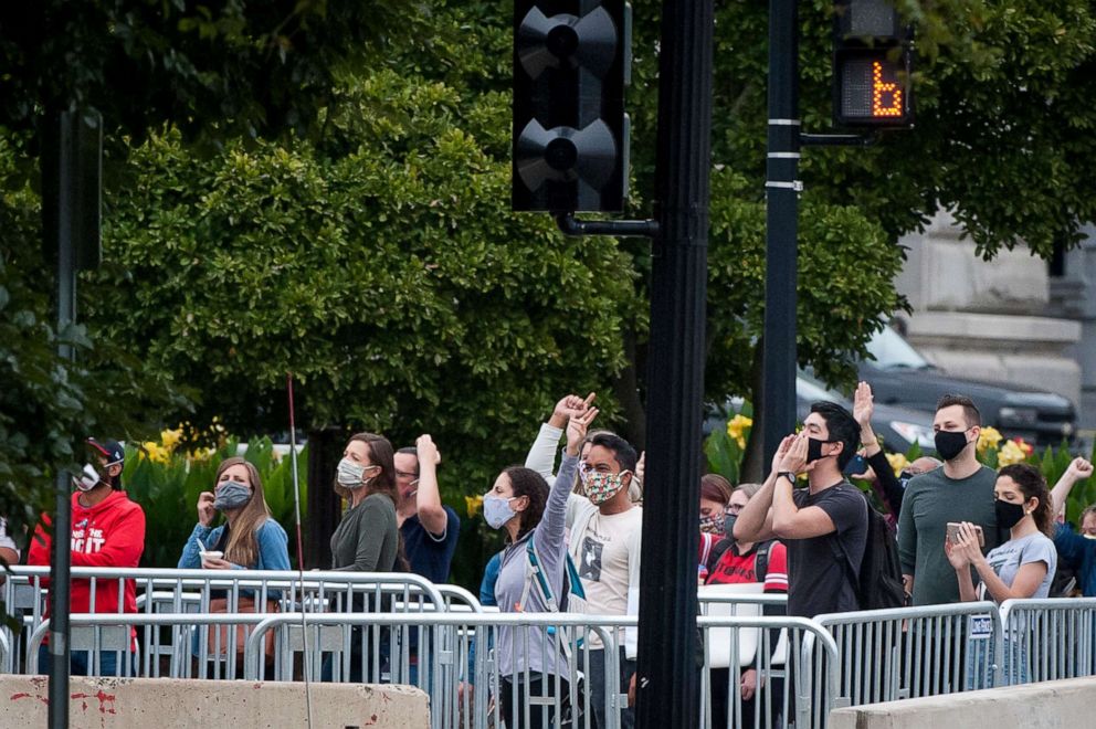 PHOTO: People in the crowd boo President Donald Trump, and first lady Melania Trump as they pay their respects as Supreme Court Justice Ruth Bader Ginsburg at the Supreme Court  in Washington, D.C., Sept. 24, 2020.