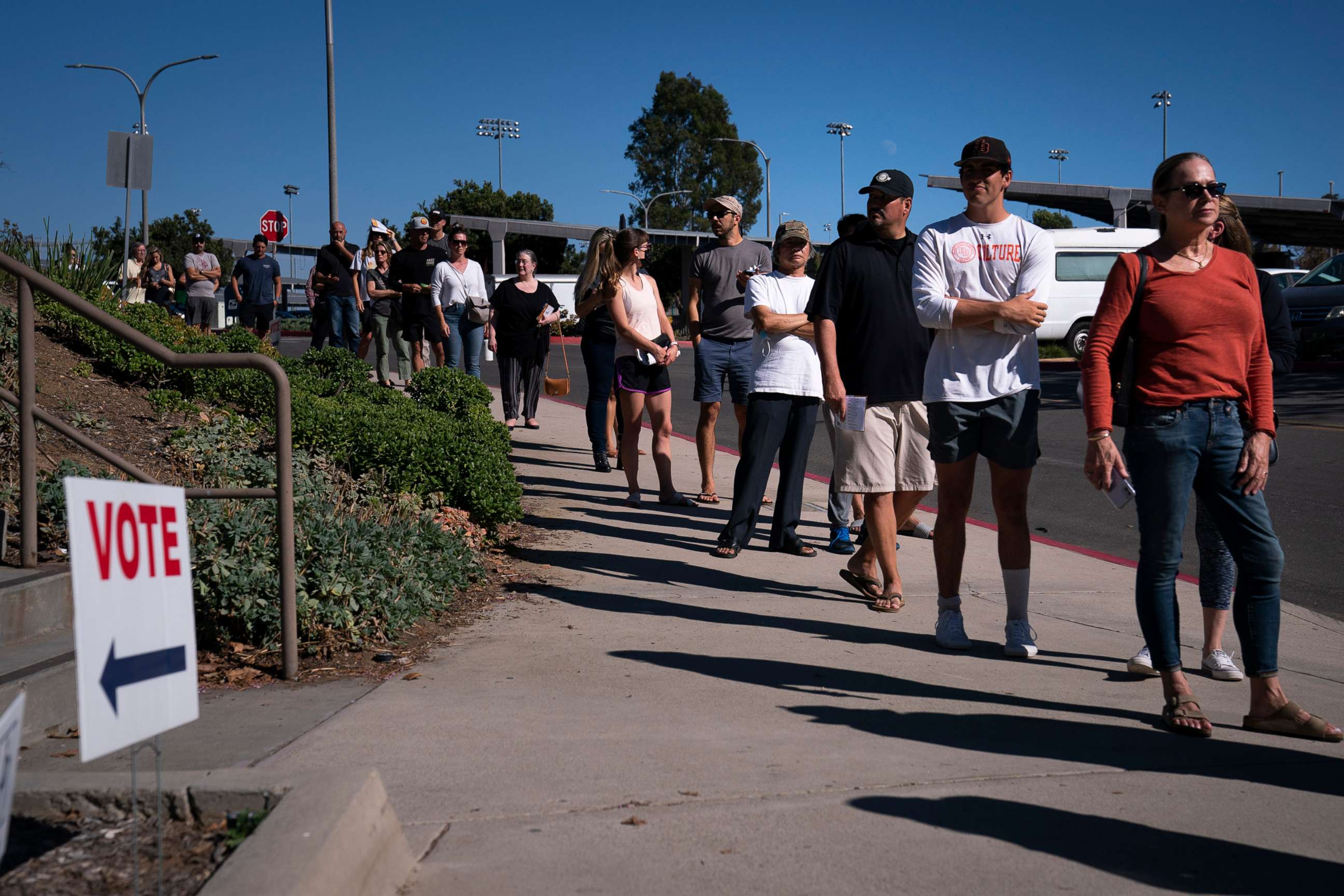 PHOTO: People wait in line outside a vote center to cast their ballots, Sept. 14, 2021, in Huntington Beach, Calif. 