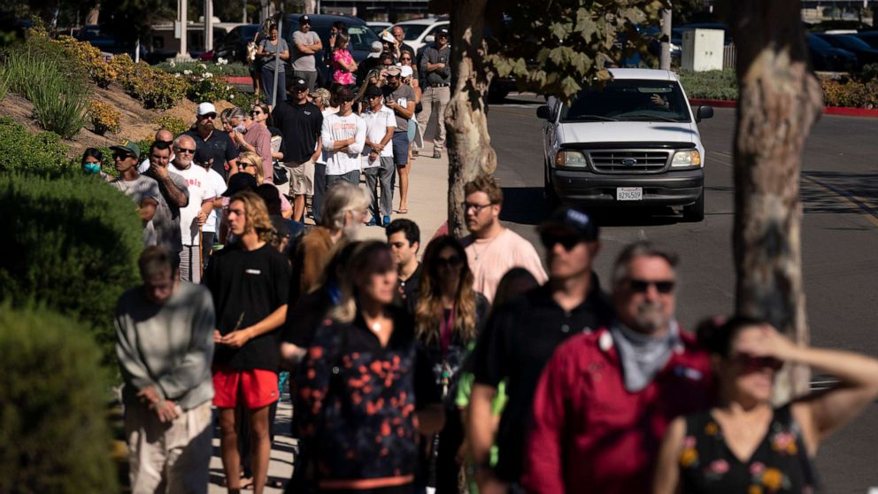 PHOTO: People wait in line to vote outside a vote center Tuesday, Sept. 14, 2021, in Huntington Beach, Calif.