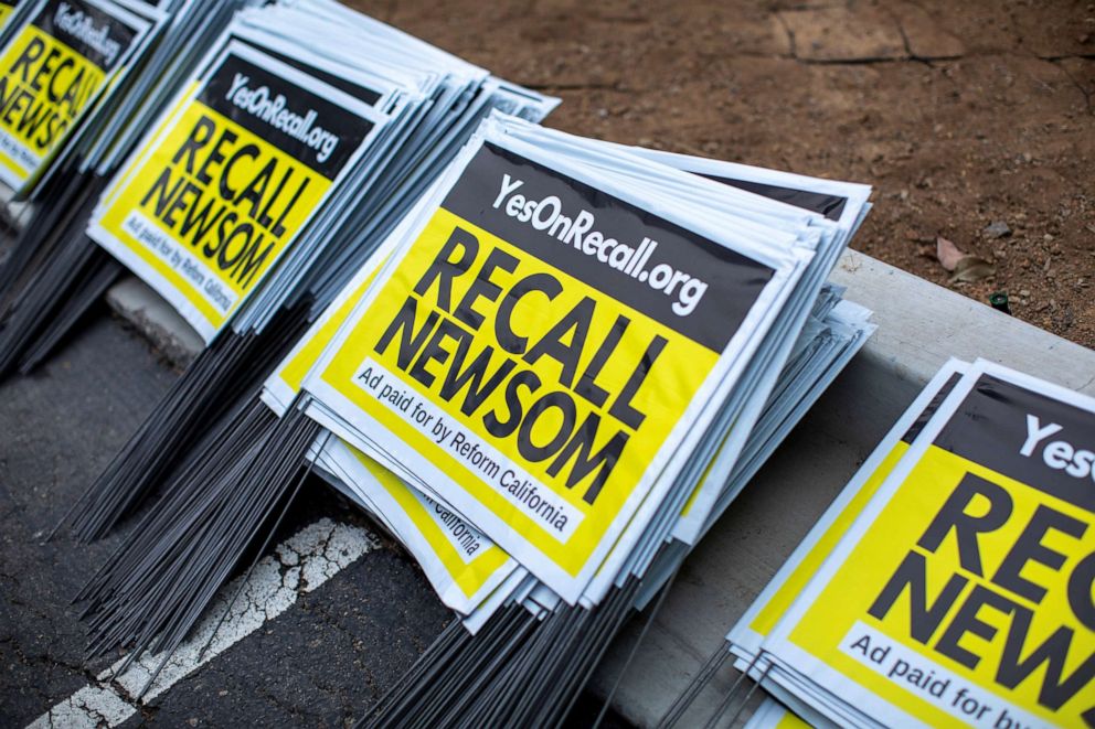 Yard signs are shown at a rally for the recall of California Gov. Gavin Newsom in Carlsbad, California on June 30, 2021.