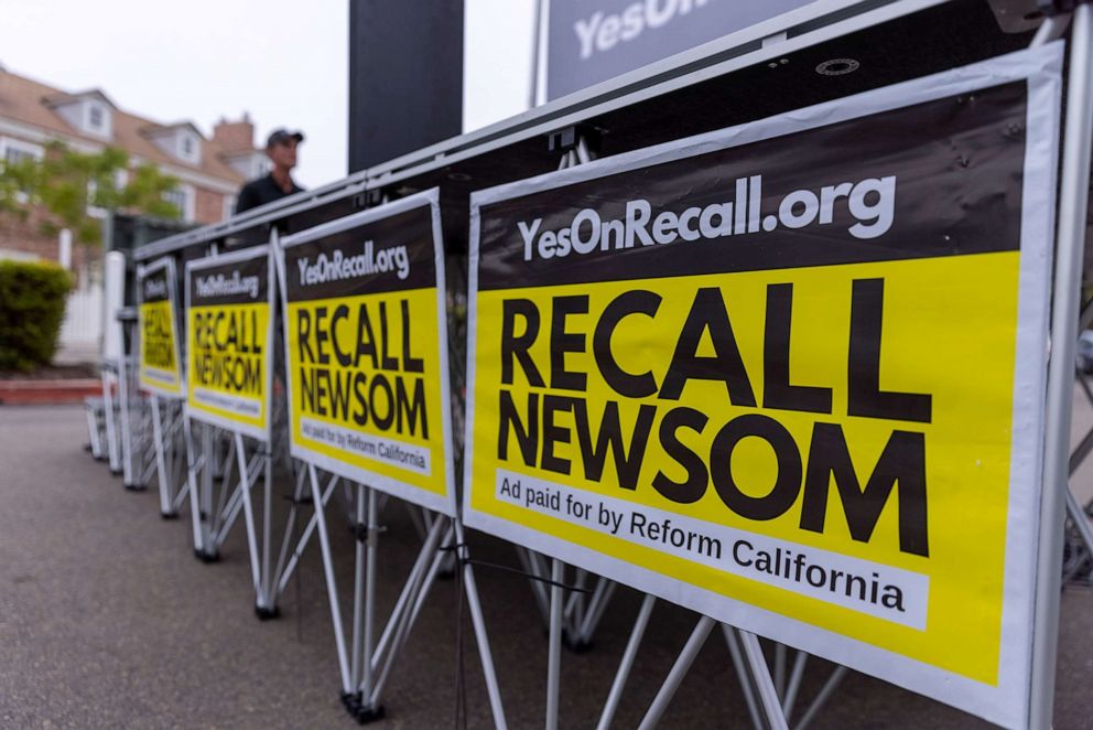 PHOTO: Signs are shown at a rally for the recall campaign of California governor Gavin Newsom in Carlsbad, Calif., June 30, 2021. 