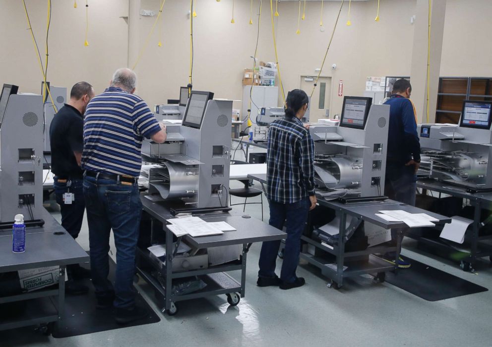 PHOTO: Election officials work at counting machines as they are calibrated before a recount at the Broward County Supervisor of Elections Office, Nov. 11, 2018, in Lauderhill, Fla.