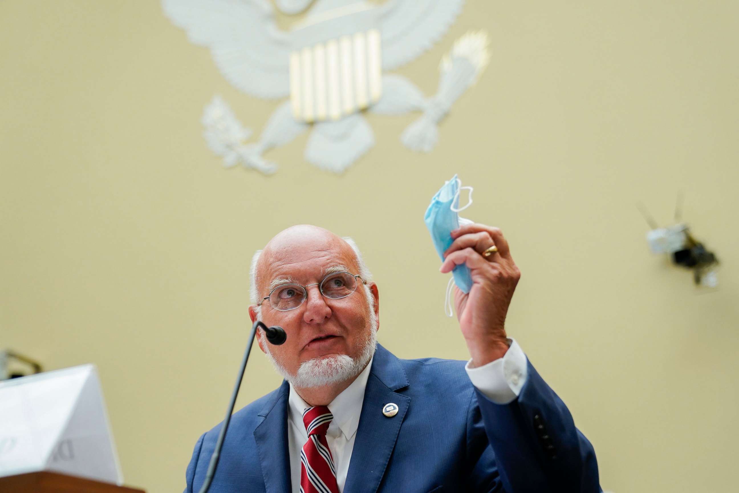 PHOTO: Robert Redfield, director of the Centers for Disease Control and Prevention, holds a protective mask while speaking during hearing on Capitol Hill, July 31, 2020.