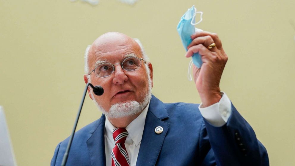PHOTO: Robert Redfield, director of the Centers for Disease Control and Prevention, holds a protective mask while speaking during hearing on Capitol Hill, July 31, 2020.