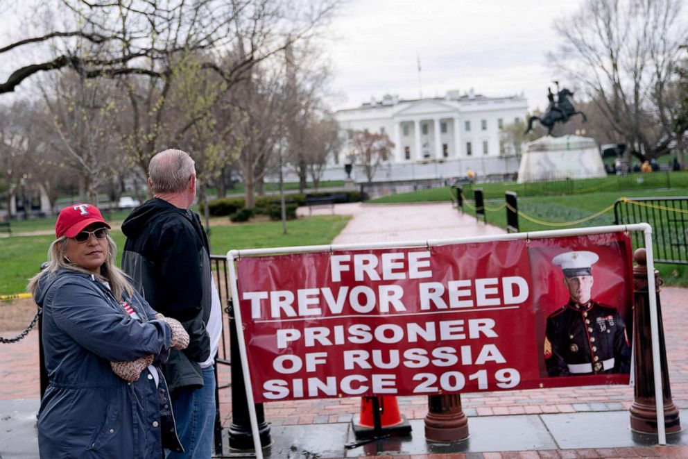 PHOTO: In this file photo taken on March 30, 2022, Paula and Joey Reed, parents of Trevor Reed, stand next to a banner reading Free Trevor Reed in Lafayette Square near the White House in Washington, D.C.