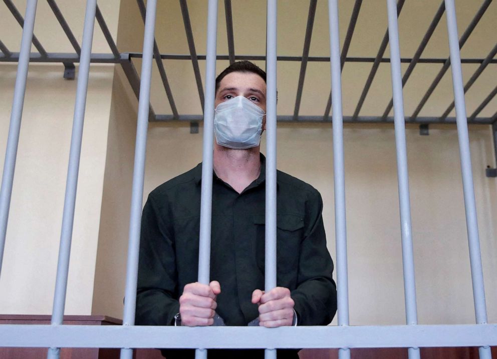 PHOTO: Former U.S. Marine Trevor Reed, who was detained in 2019 and accused of assaulting police officers, stands inside a defendants' cage during a court hearing in Moscow, July 30, 2020.
