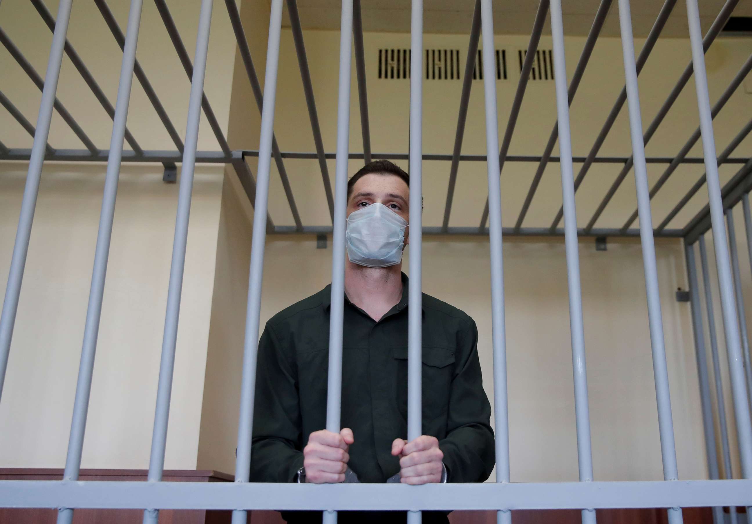 PHOTO: Former Marine Trevor Reed, who was detained in 2019 and accused of assaulting police officers, stands inside a defendants' cage during a court hearing in Moscow, July 30, 2020. 