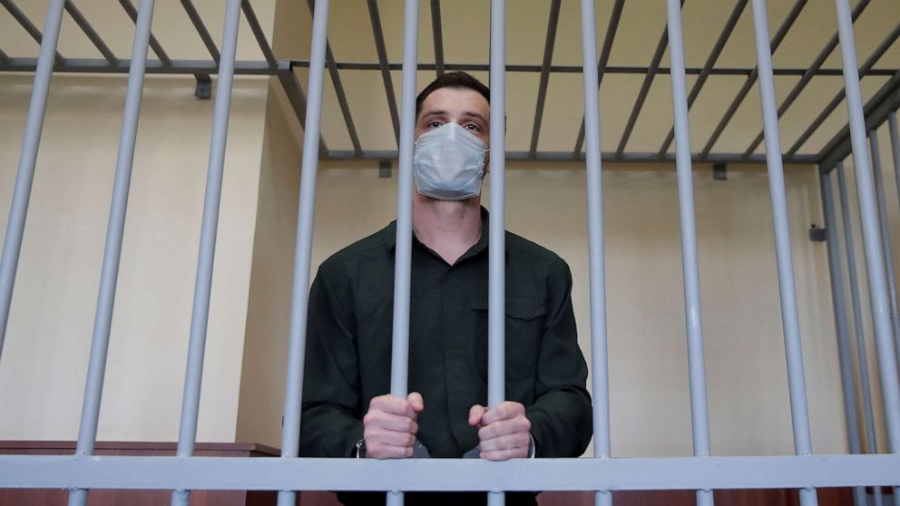PHOTO: Former Marine Trevor Reed, who was detained in 2019 and accused of assaulting police officers, stands inside a defendants' cage during a court hearing in Moscow, July 30, 2020. 