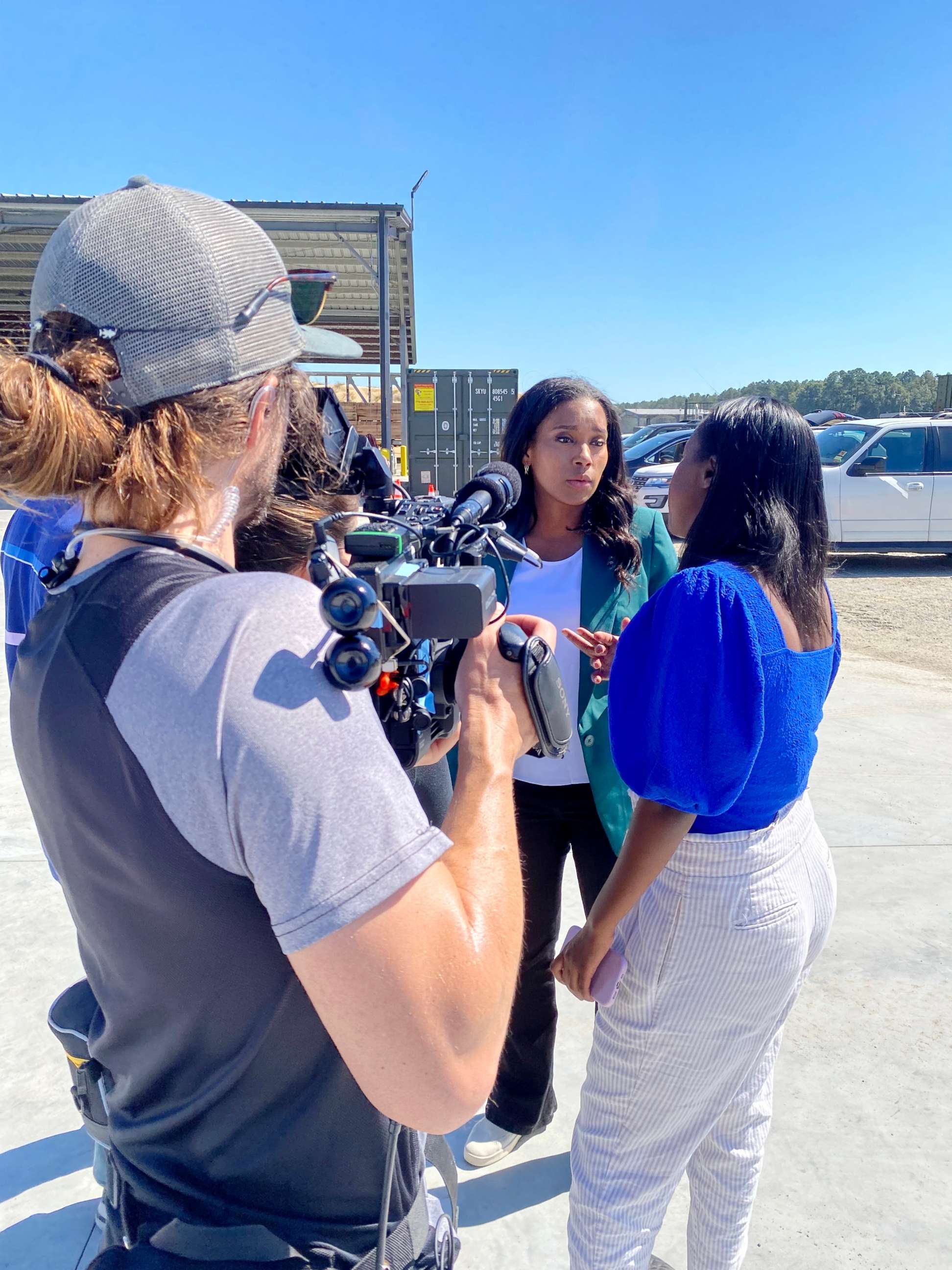 PHOTO: ABC congressional correspondent Rachel Scott (center) talks with ABC News embedded campaign reporter Lalee Ibssa (right) at a Herschel Walker rally in Wadley, Georgia.