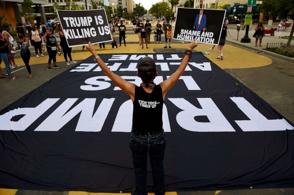PHOTO: Demonstrators rally to protest President Donald Trump's acceptance of the Republican National Convention nomination at Black Lives Matter plaza across from the White House, Aug. 27, 2020, in Washington.